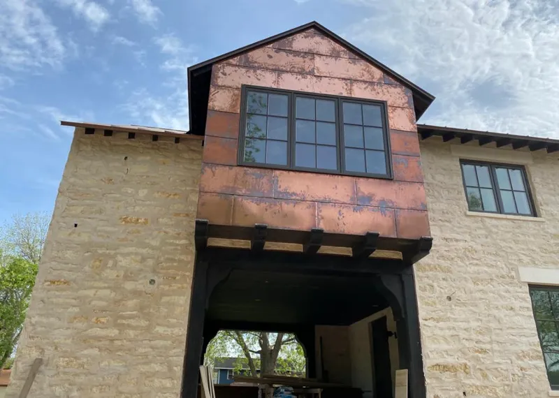 Copper metal panel facade on a stone building for Skylight Installation in Gulf Park Estates