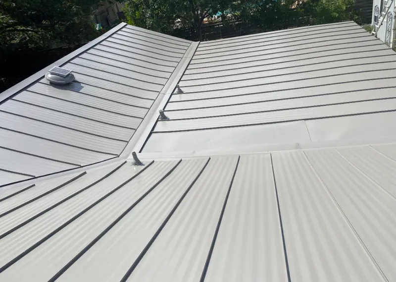 Solar attic fan installed on a metal roof for Roof Ventilation in Gulf Park Estates
